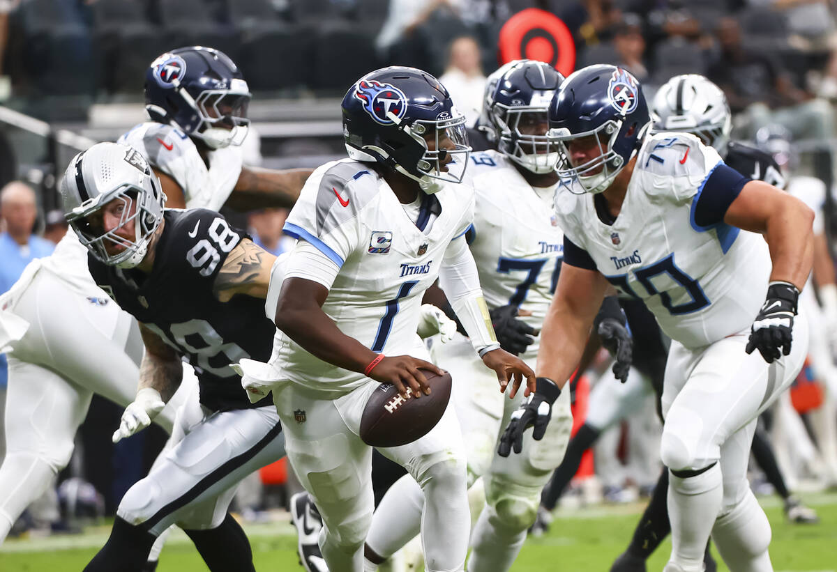 Raiders defensive end Maxx Crosby (98) eyes Tennessee Titans quarterback Cam Ward (1) during th ...