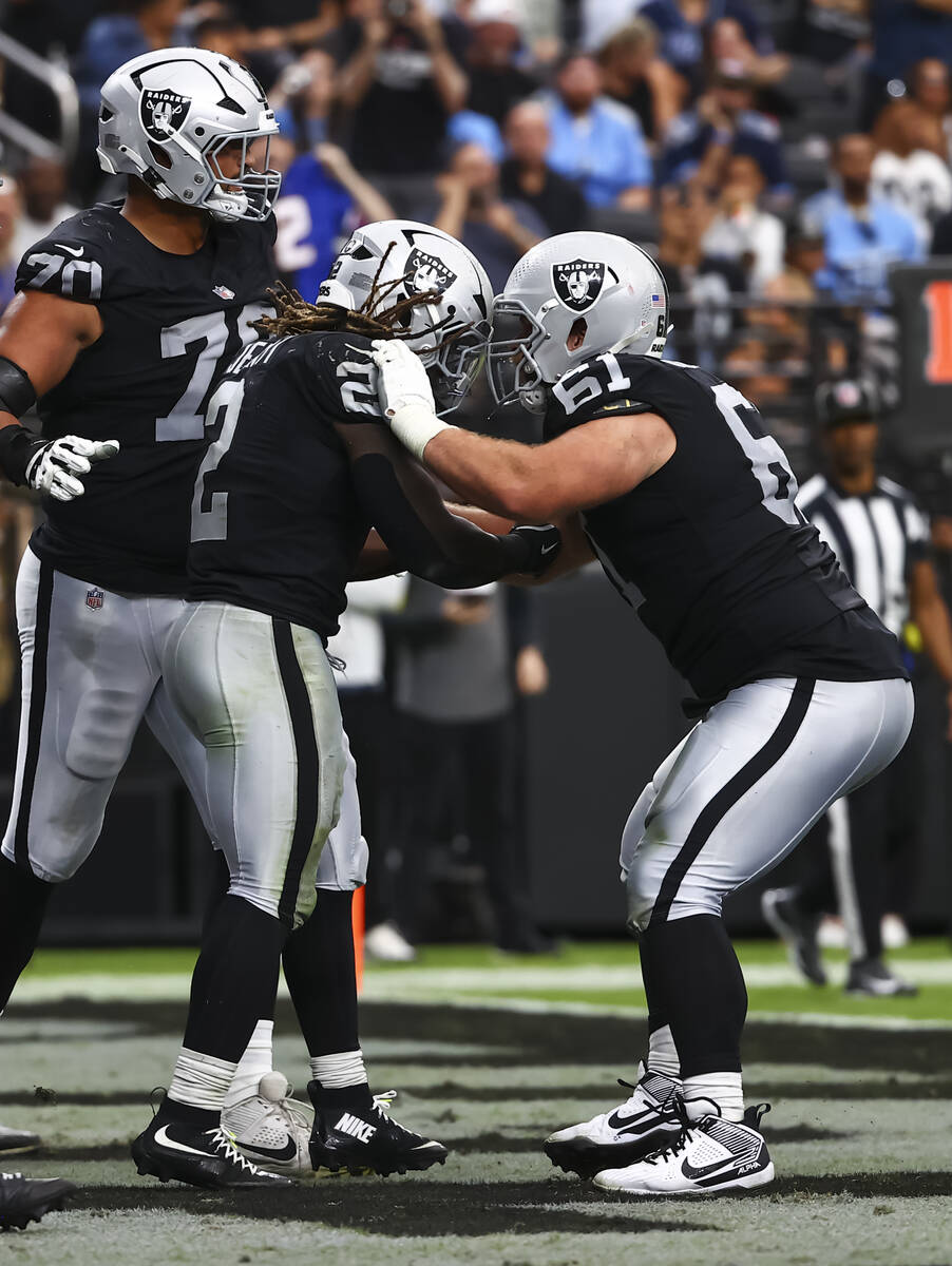 Raiders running back Ashton Jeanty (2) celebrates his touchdown with Raiders guard Jordan Mered ...