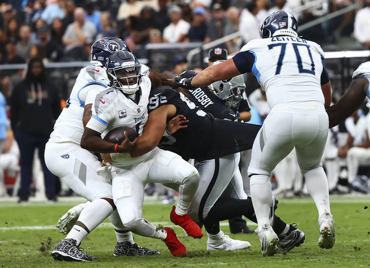 Tennessee Titans quarterback Cam Ward (1) gets sacked by Raiders defensive tackle Leki Fotu (95 ...