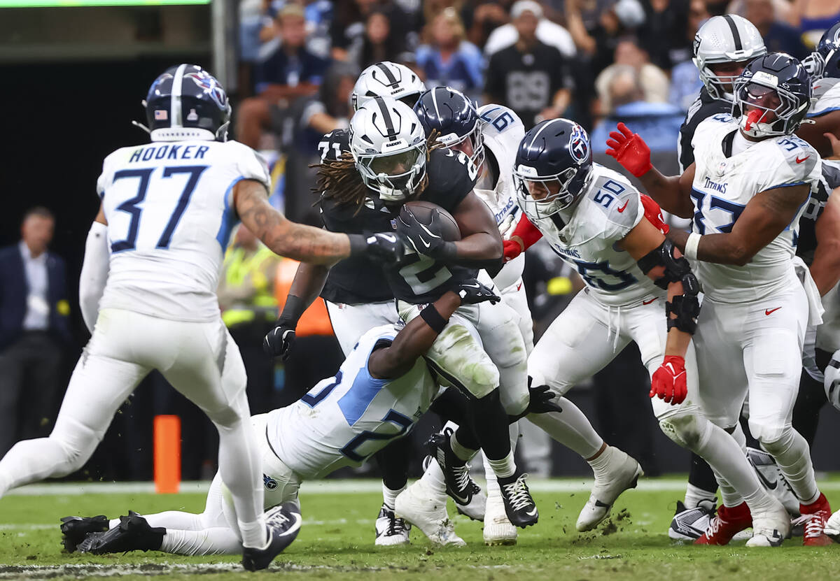 Raiders running back Ashton Jeanty (2) runs the ball as Tennessee Titans defense moves in for t ...