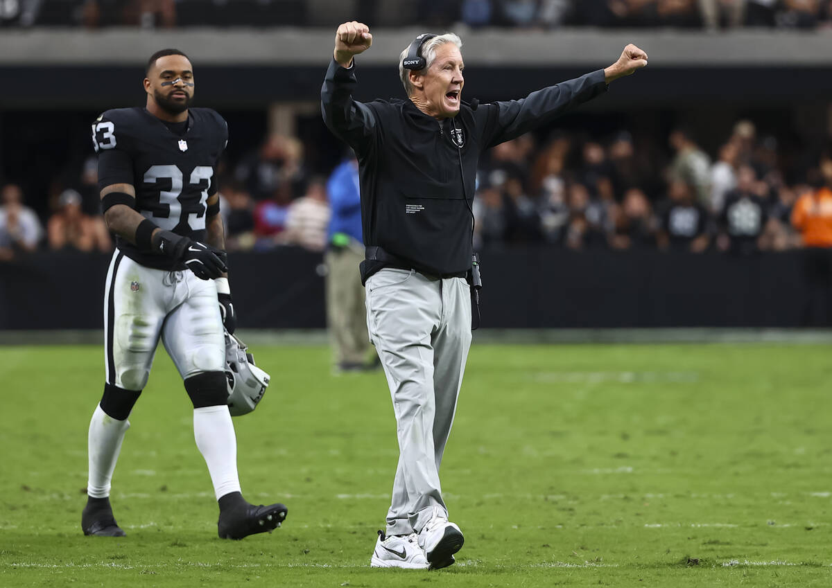 Raiders head coach Pete Carroll celebrates during the second half of an NFL game against the Te ...