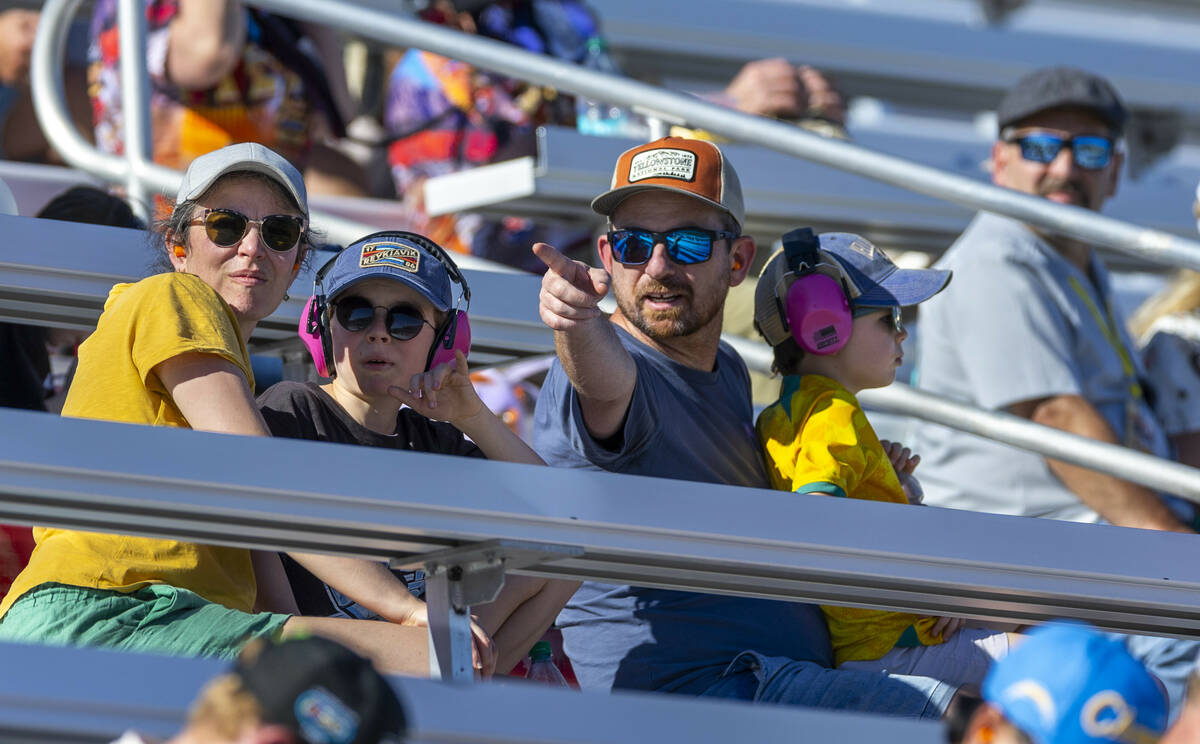 Fans watch the action as drivers move past during the NASCAR Cup Series South Point 400 race at ...