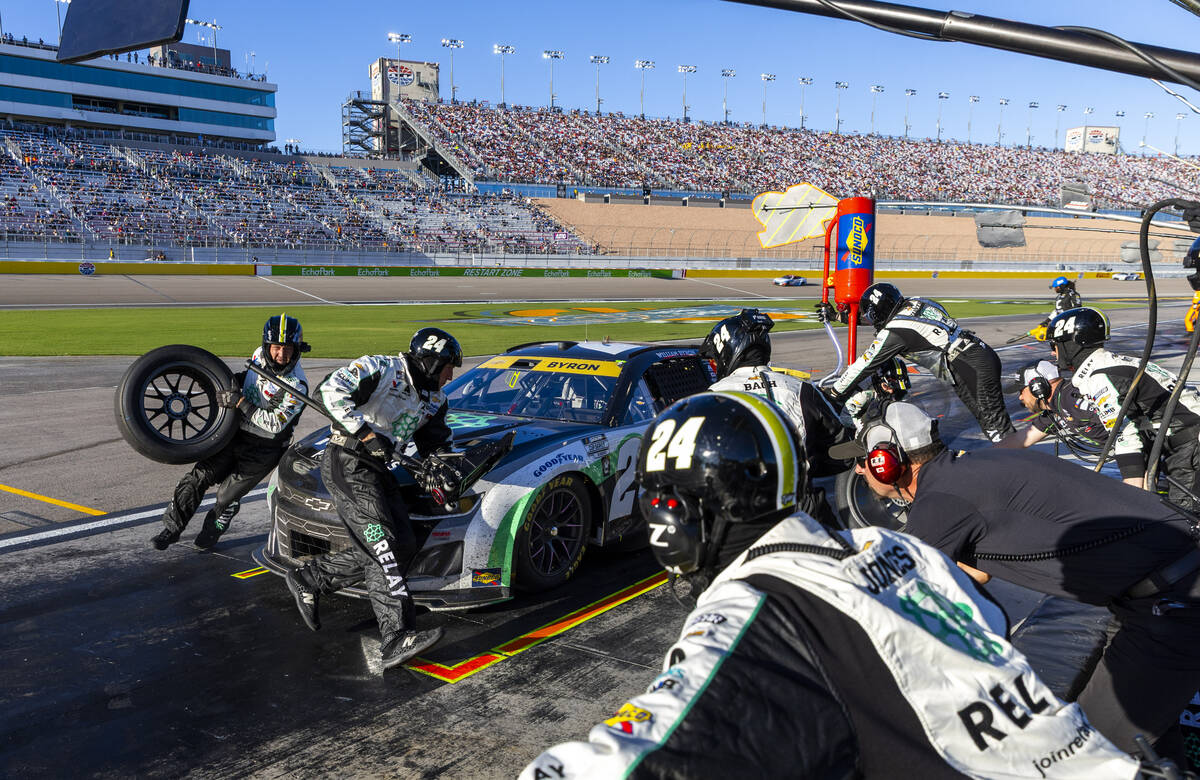 The pit crew for William Byron (24) makes a tire change quickly to keep him in the lead during ...