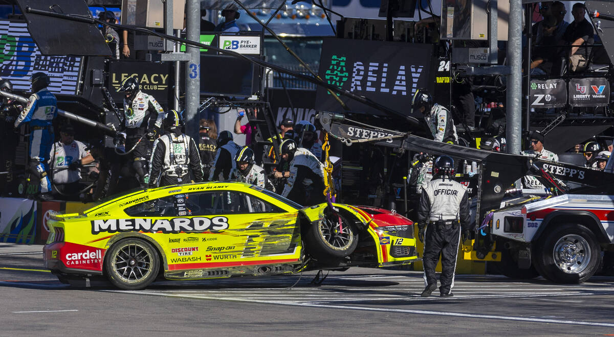 Ryan Blaney (12) has his car towed off the track following a crash during the NASCAR Cup Series ...
