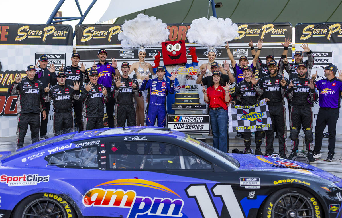 Denny Hamlin (11), his pit crew and others hold up a six signifying his wins on the season as t ...