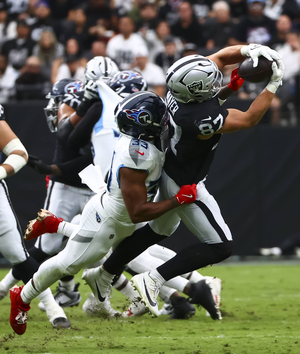 Raiders tight end Michael Mayer (87) pulls in a pass under pressure from Tennessee Titans safet ...