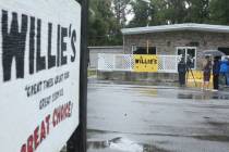 People stand outside of Willie's Bar and Grill in St Helena Island, S.C. after a shooting ...