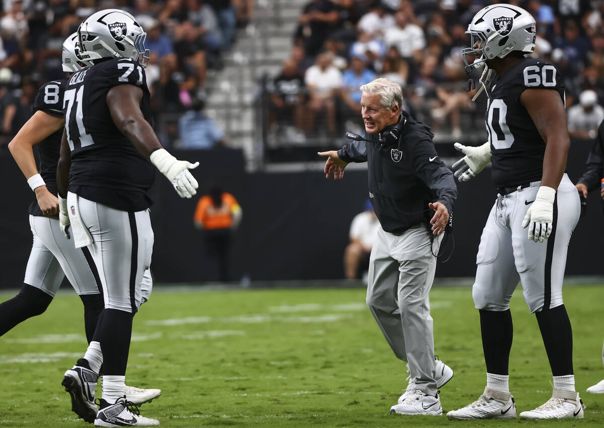 Raiders head coach Pete Carroll celebrates with Raiders offensive tackle DJ Glaze (71) after th ...