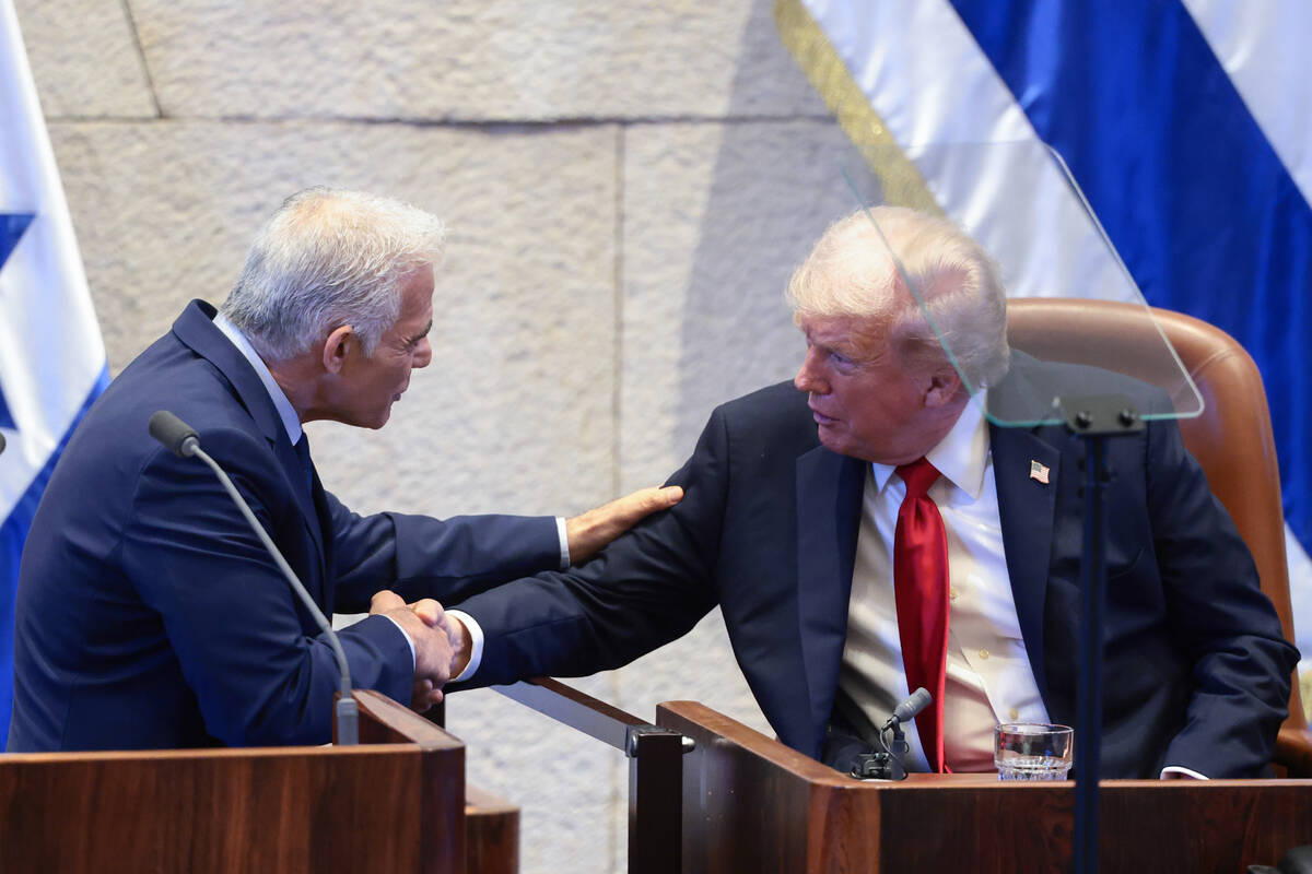 President Donald Trump shakes hands with Israeli opposition leader Yair Lapid at the Knesset, I ...
