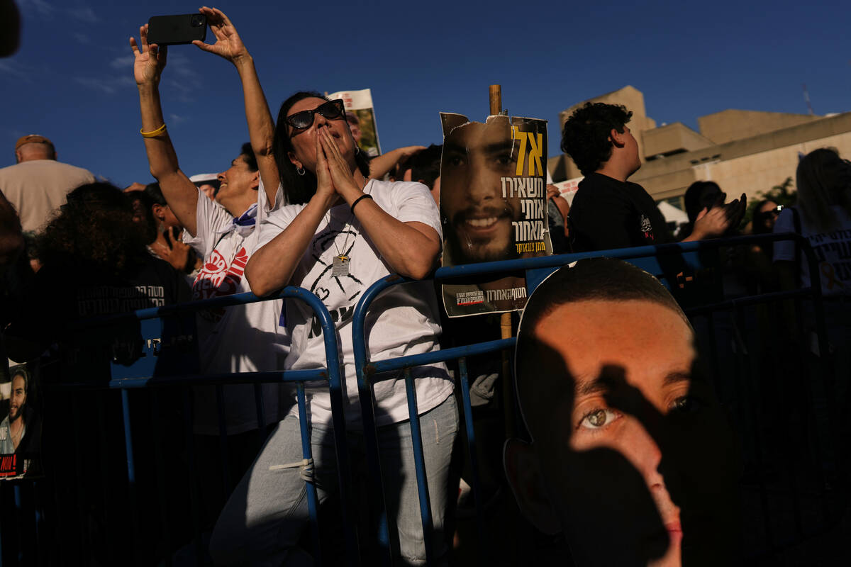 People gather to watch a live broadcast of Israeli hostages released from Gaza at a plaza known ...
