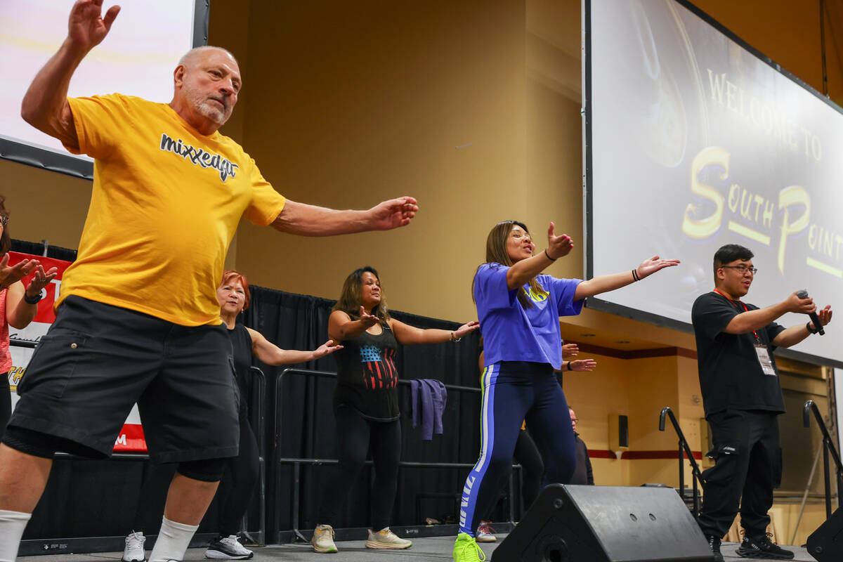 Dancers take to the stage, leading a live Zumba class for audience members at The Aging Wellnes ...