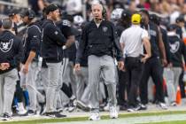 Raiders head coach Pete Carroll walks the sideline during the first half of an NFL game against ...