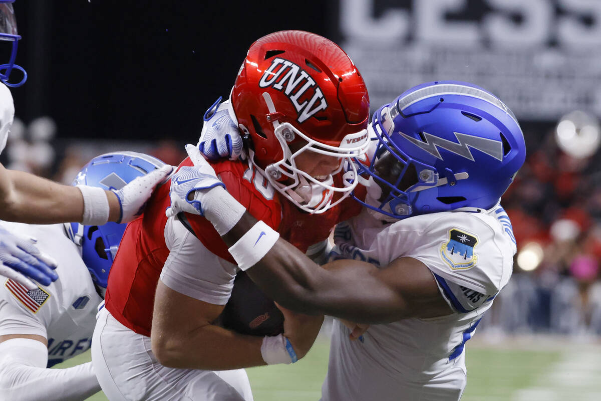 UNLV quarterback Anthony Colandrea (10) scores a touchdown as Air Force Falcons defensive back ...