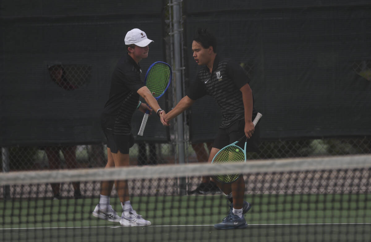 Faith Lutheran’s Davey Gluth, left, and Paul Williams celebrate a play against Palo Verd ...