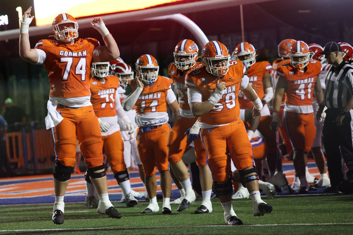 Bishop Gorman offensive lineman Devin Entsminger (74) celebrates with teammates after a first h ...
