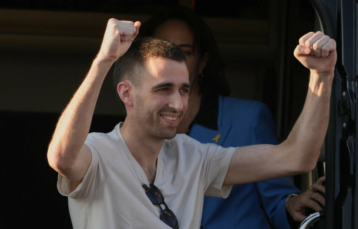 Freed Israeli hostage Avinatan Or gestures from a van as he arrives at Beilinson hospital in Pe ...