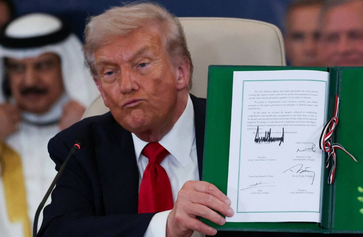 President Donald Trump holds a signed document during a summit to support ending the more than ...