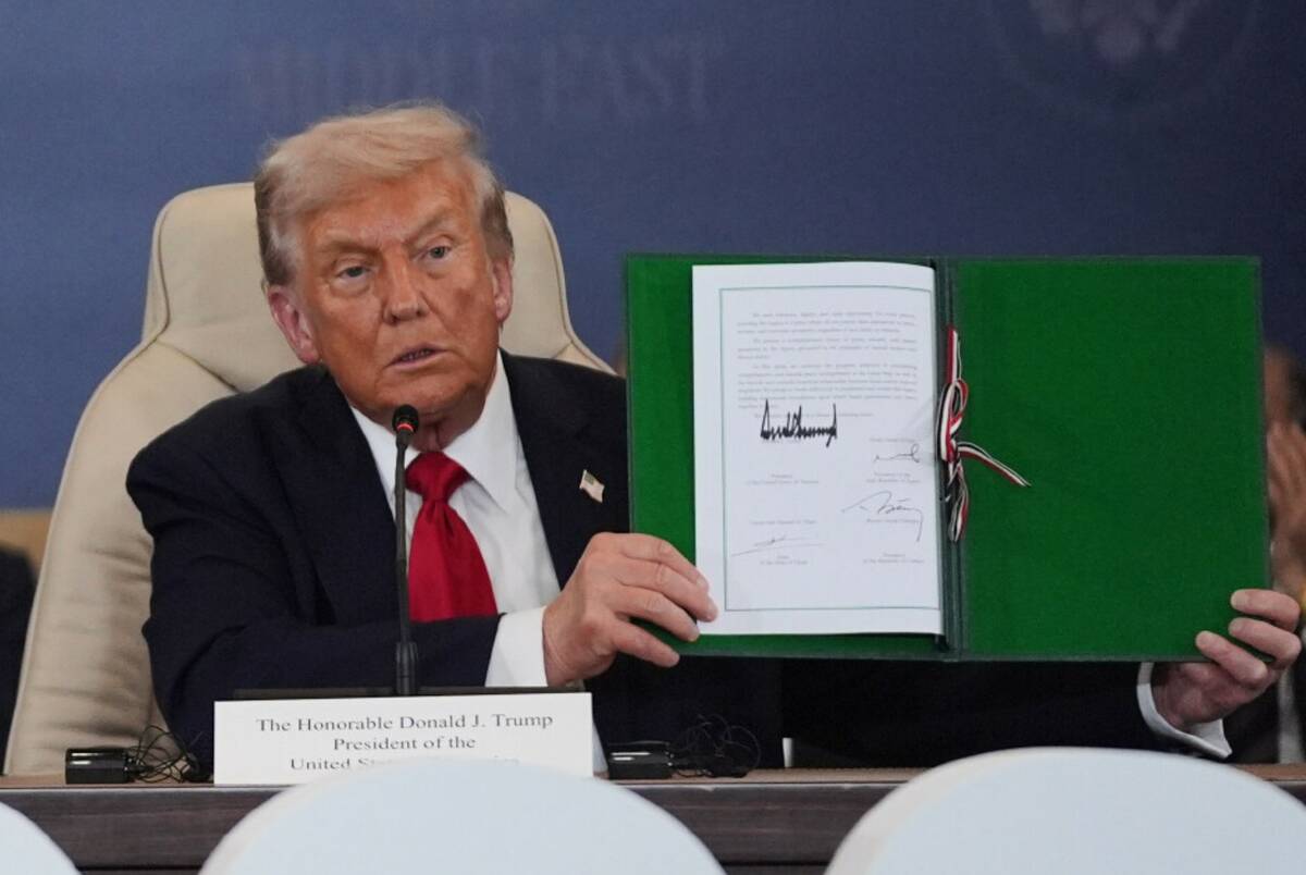 President Donald Trump holds a signed document during a summit to support ending the more than ...