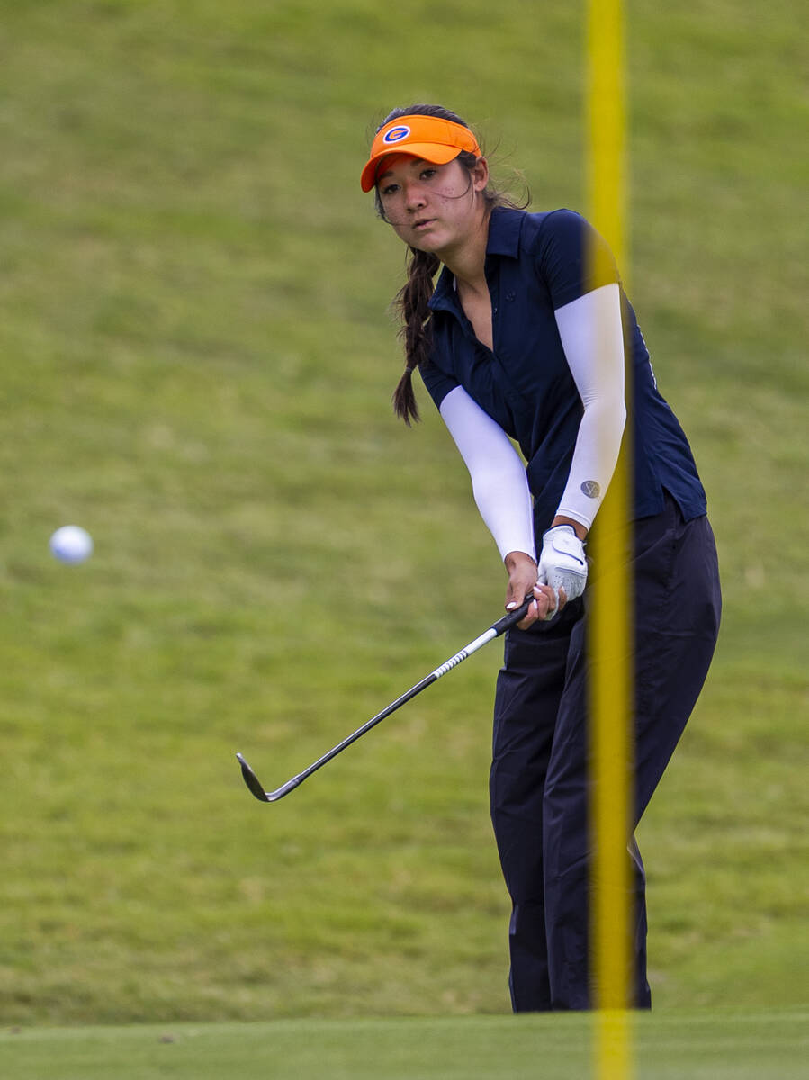 Bishop Gorman's Alyson Wasserburger chips a ball onto the green during the 5A girls golf s ...