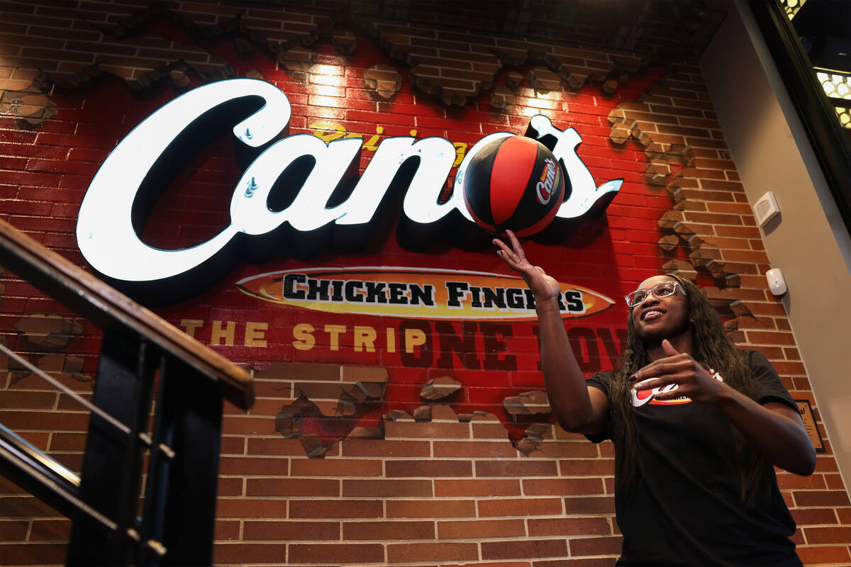 Aces guard Jackie Young spins a ball on her finger at Raising Cane’s on the Strip Tuesda ...