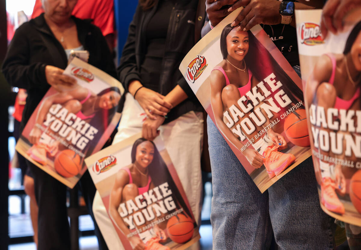 Fans wait in line to meet Aces guard Jackie Young at Raising Cane’s on the Strip Tuesday ...