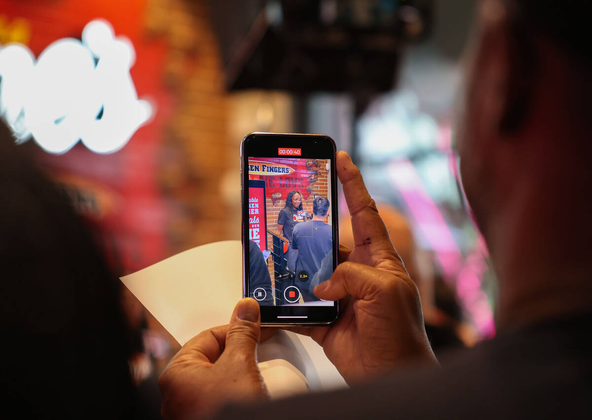Fans take video of Aces guard Jackie Young at Raising Cane’s on the Strip Tuesday, Oct. ...