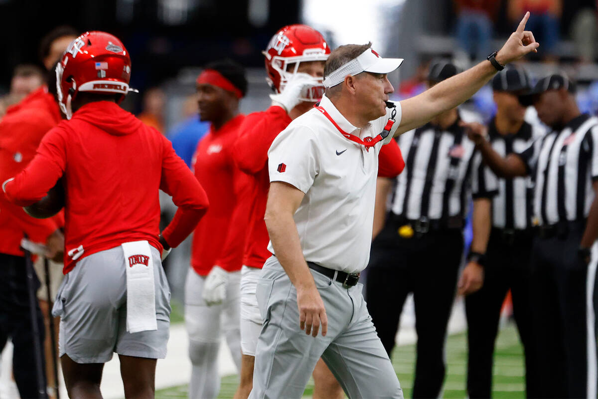 UNLV head coach Daniel Mullen signals as his players prepare to warm up to face Air Force Falco ...