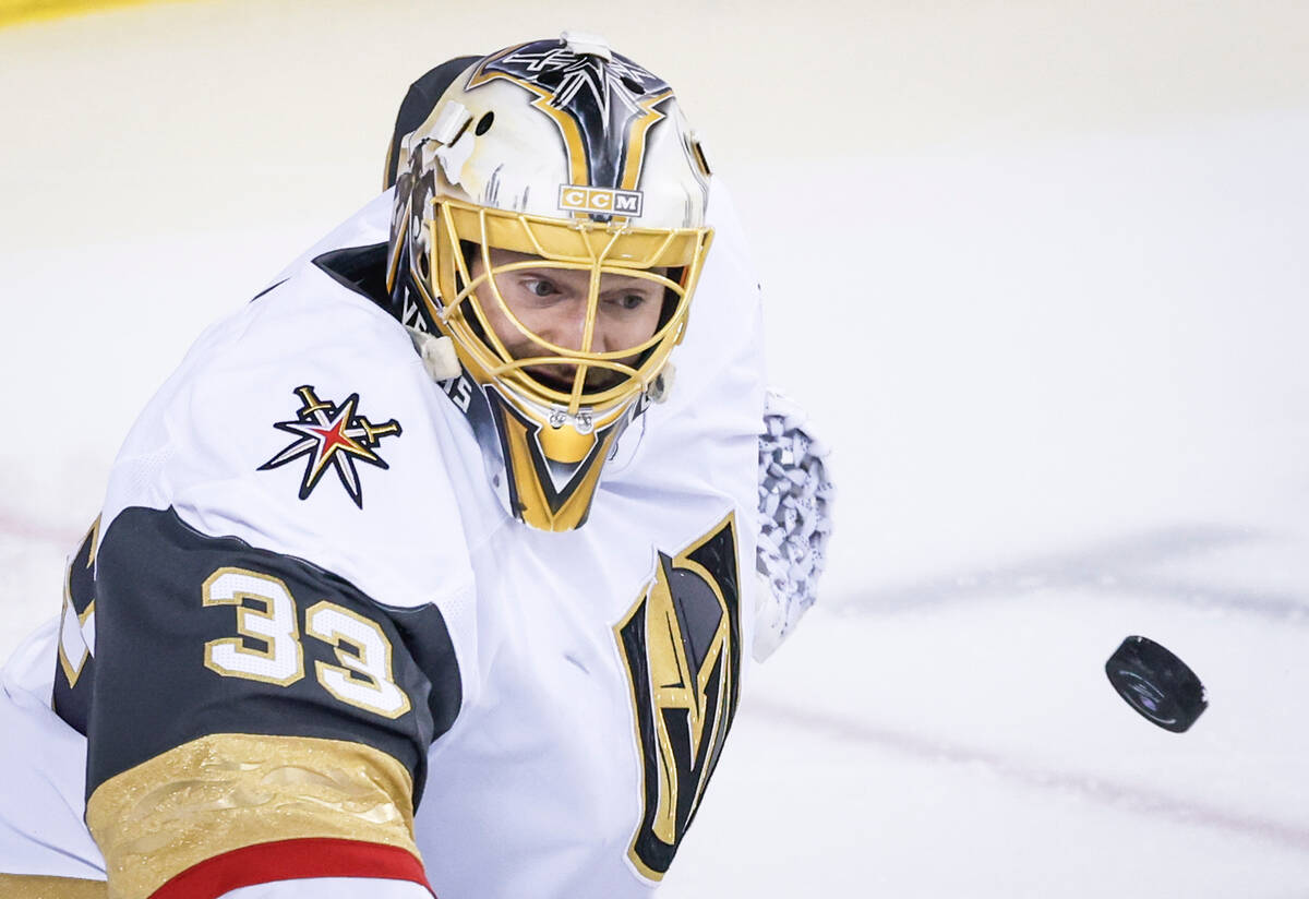 Vegas Golden Knights goalie Adin Hill keeps his eye on the puck during first period NHL hockey ...