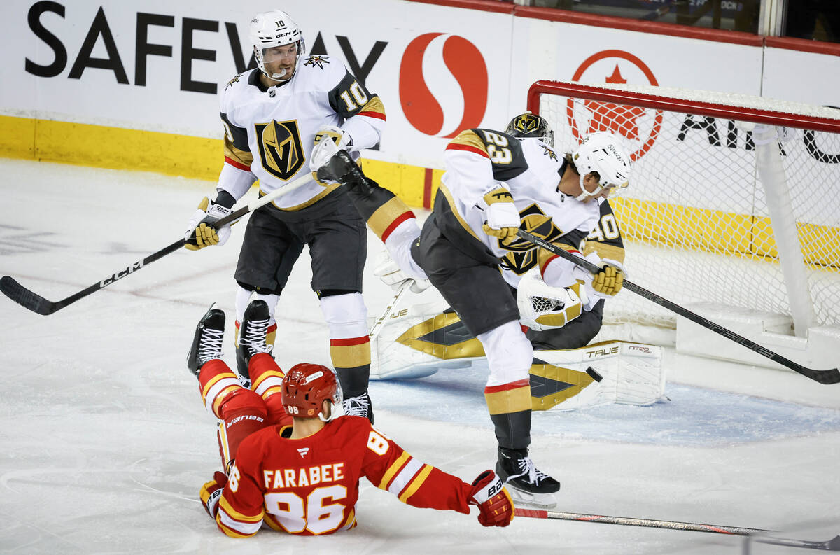 Vegas Golden Knights' Cole Reinhardt, right, leaps over Calgary Flames' Joel Farabee, ...
