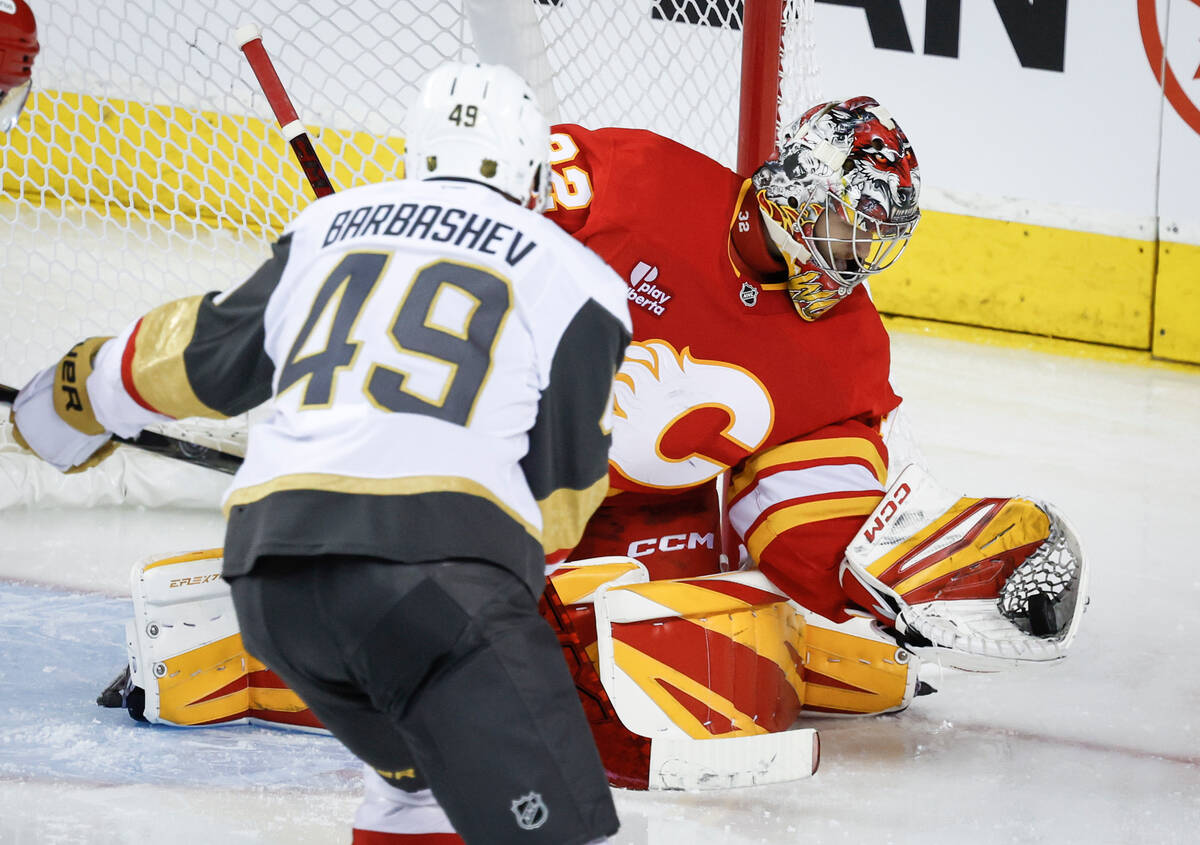 Vegas Golden Knights' Ivan Barbashev (49) has his shot grabbed by Calgary Flames goalie Du ...
