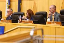 Clark County Commissioners Jim Gibson, left, and Justin Jones, right, listen as Commissioner Ma ...