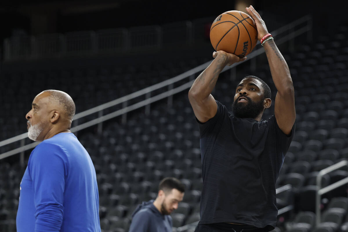 Dallas Mavericks point guard Kyrie Irving runs through shooting drills after practice at T-Mobi ...