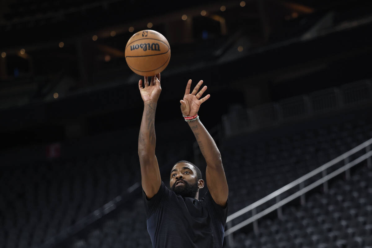 Dallas Mavericks point guard Kyrie Irving runs through shooting drills after practice at T-Mobi ...