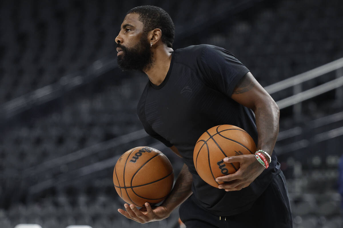 Dallas Mavericks point guard Kyrie Irving runs through shooting drills after practice at T-Mobi ...