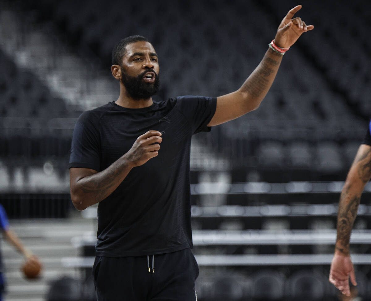 Dallas Mavericks point guard Kyrie Irving runs through shooting drills after practice at T-Mobi ...