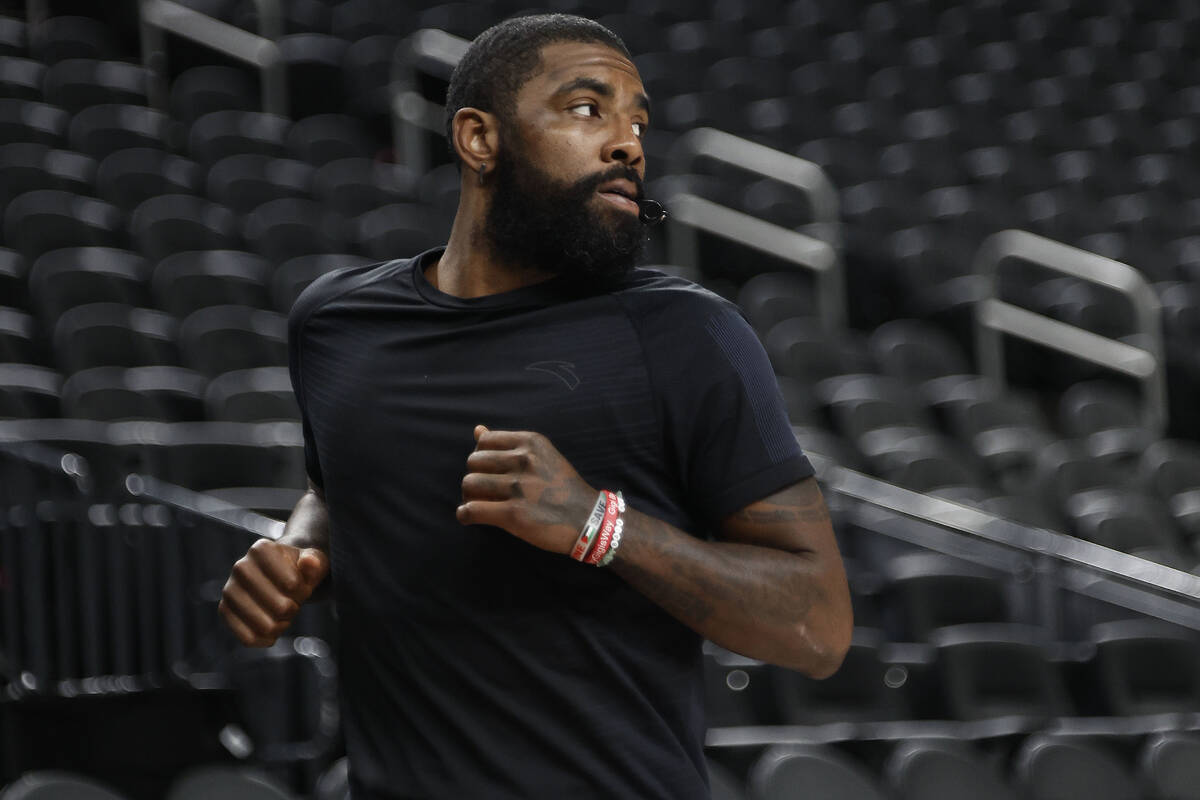 Dallas Mavericks point guard Kyrie Irving runs through shooting drills after practice at T-Mobi ...
