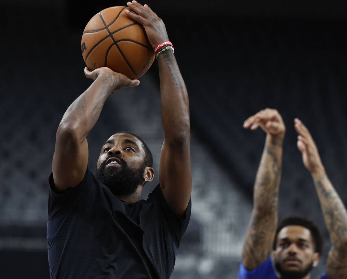 Dallas Mavericks point guard Kyrie Irving runs through shooting drills after practice at T-Mobi ...