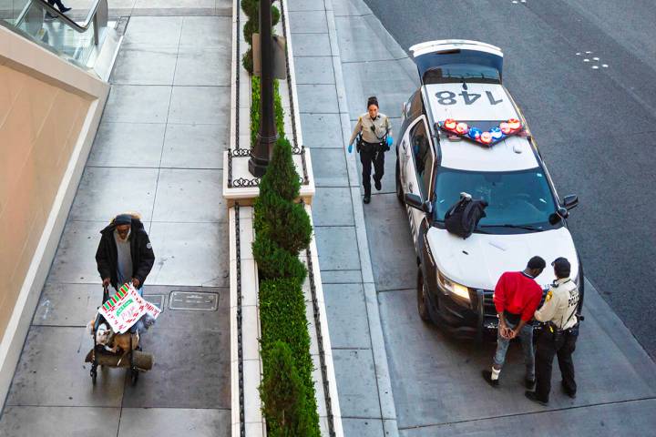 Metropolitan Police Department officers search a man who was detained near the Fashion Show Mal ...