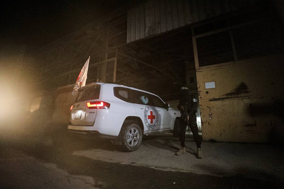 A gunman wearing the uniform of the al-Qassam Brigades, the military wing of Hamas, stands guar ...