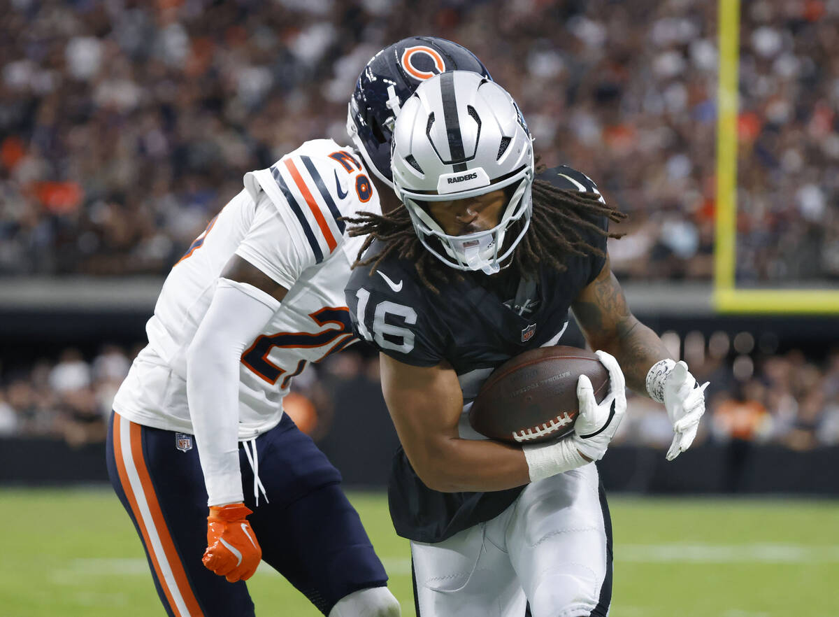 Raiders wide receiver Jakobi Meyers (16) protects the ball from Chicago Bears cornerback Nahsho ...