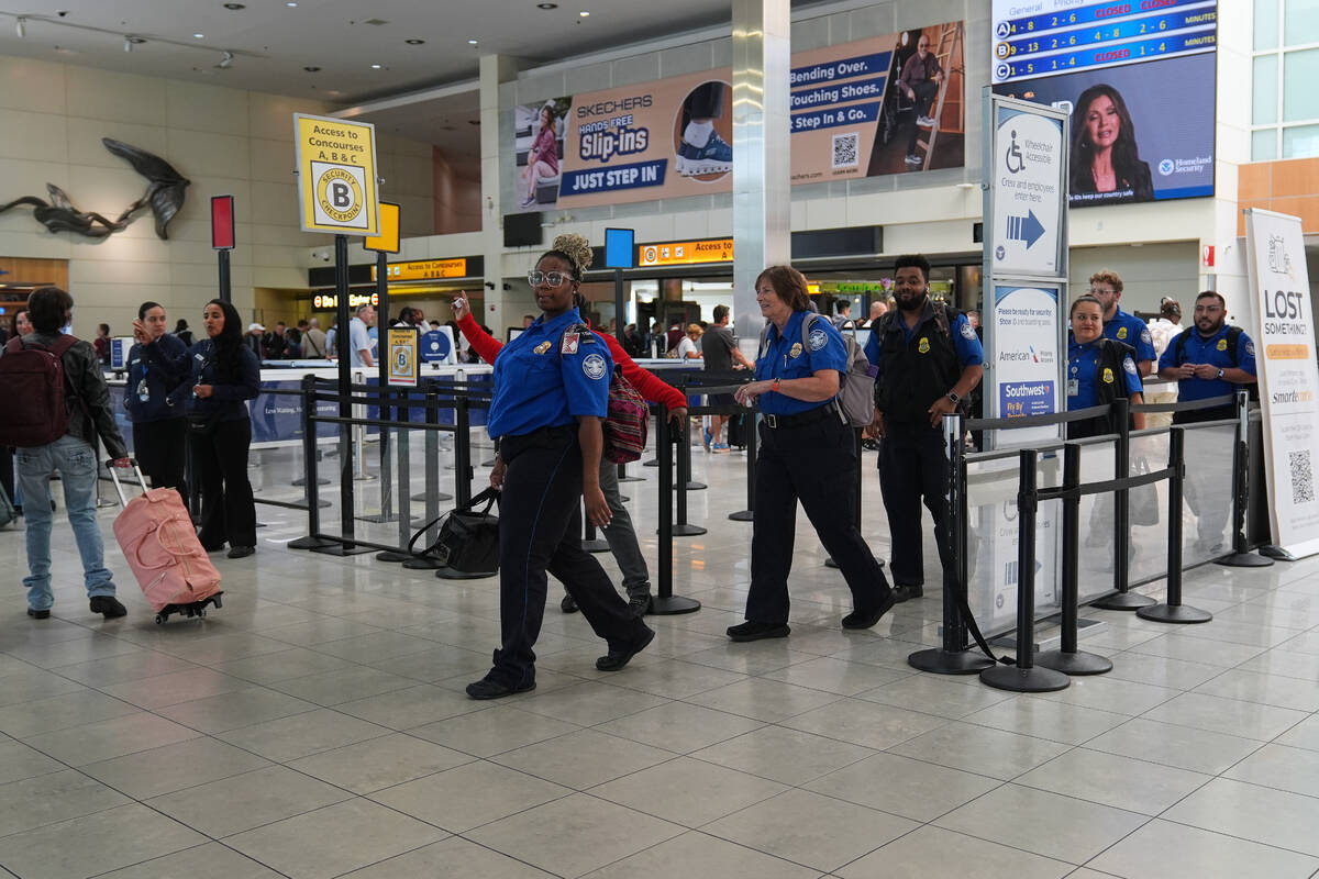 Transportation Security Administration employees leave a security checkpoint during a shift cha ...