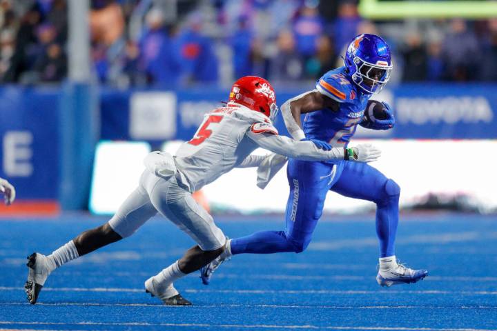 Boise State running back Dylan Riley (24) tries to push the hand of New Mexico cornerback Frank ...