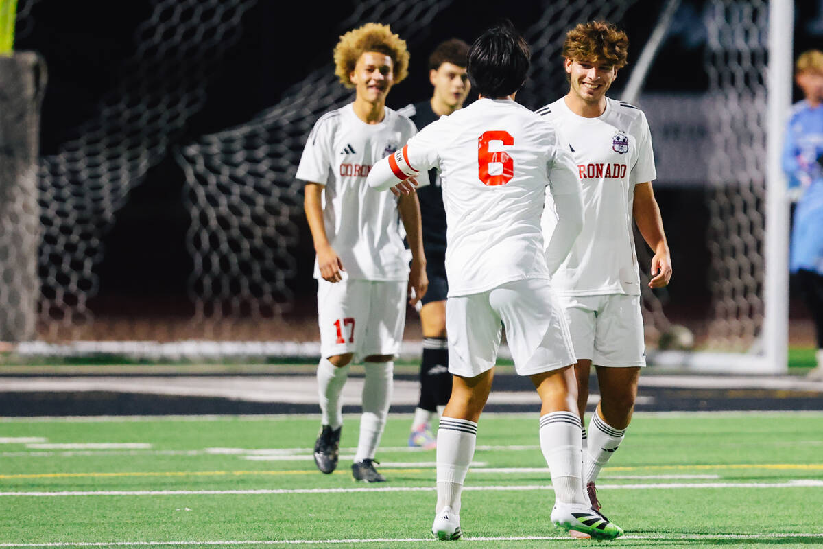 Coronado striker Gavin Flickinger (11) celebrates a goal with his teammates during a high schoo ...