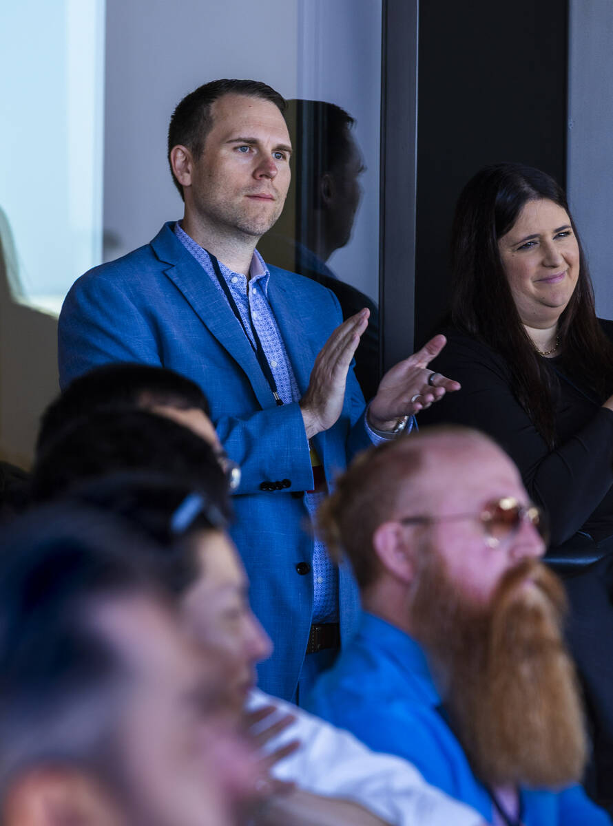 Piotr Tomasik, co-founder and President of TensorWave, applauds with others while listening tom ...