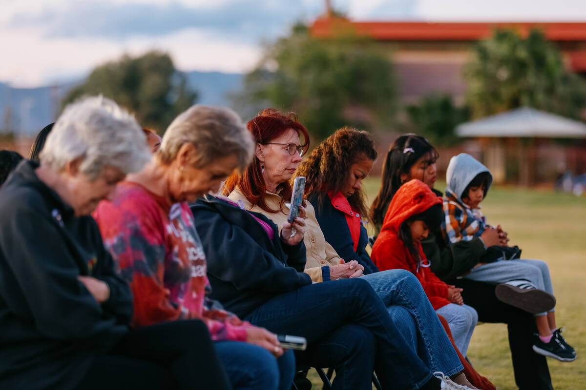 Victims’ families bow their heads in prayer during a tree dedication in honor of domesti ...