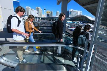 Convention attendees head to the Las Vegas Convention Center from the Boingo Monorail Station T ...