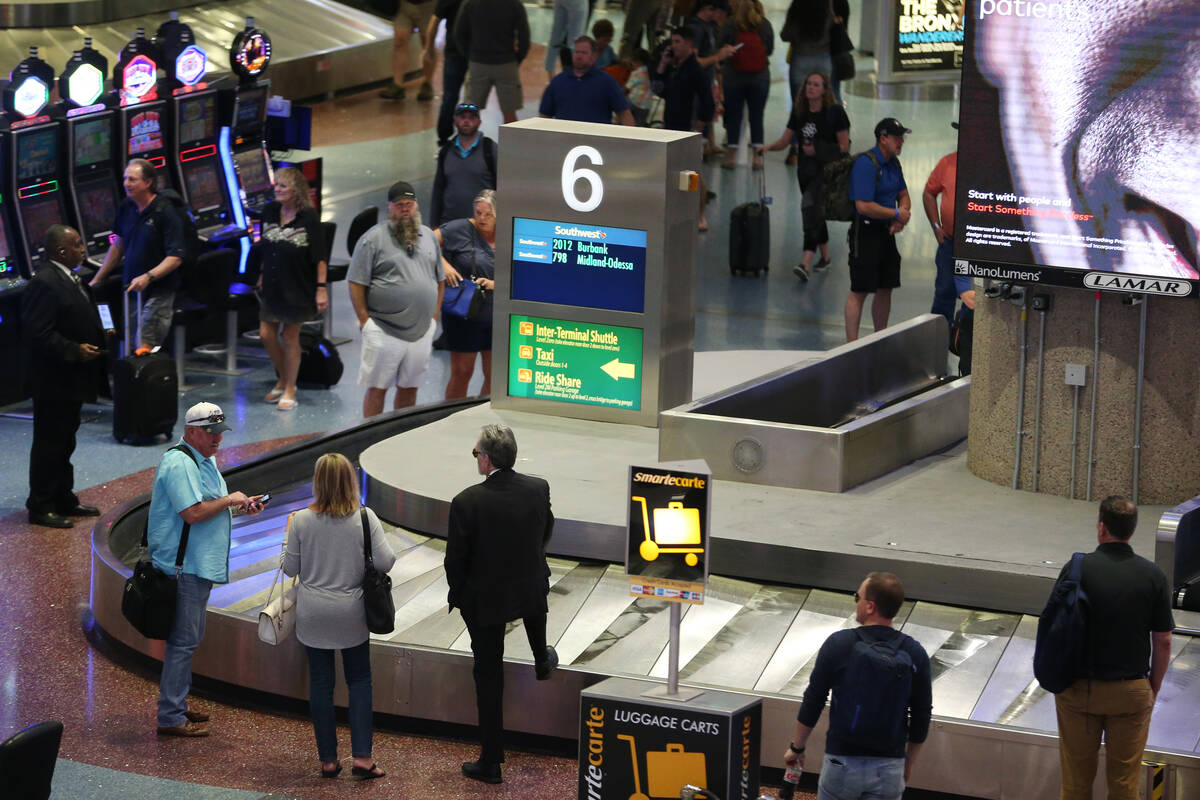 Passengers wait for their luggage in Terminal 1 at Harry Reid International Airport in Las Vega ...
