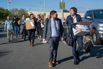Members of the Pentagon press corp carry their belongings out of the Pentagon after turning in ...