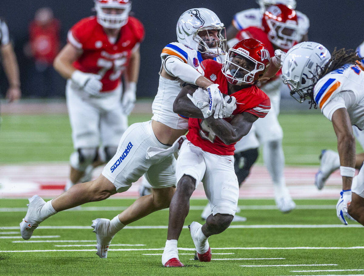 UNLV running back Jai'Den Thomas (9) battles for mare yards against the Boise State Bronco ...