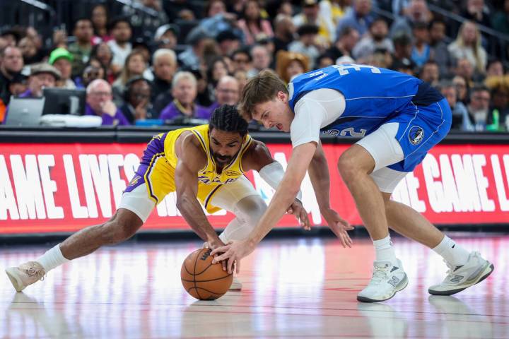 Los Angeles Lakers guard Gabe Vincent, left, and Dallas Mavericks forward Cooper Flagg (32) con ...